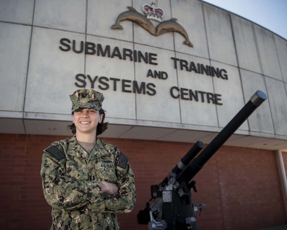 U.S. Navy officer stands in front of Submarine Training and Systems Centre